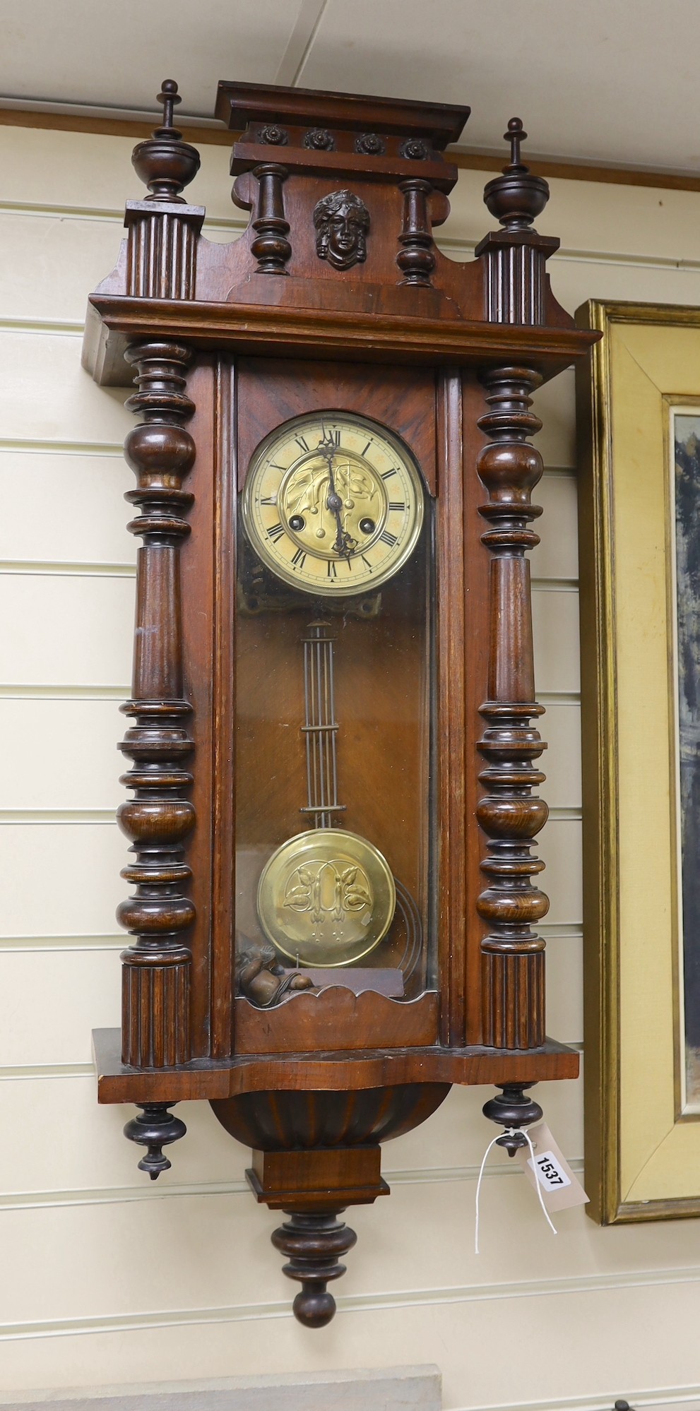 A 19th century German architectural beech and walnut wall clock, 100 cms high